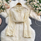 Seraphine Cutwork Cotton Shirt in ivory laid flat showing sleeve embroidery and scalloped cuff detail