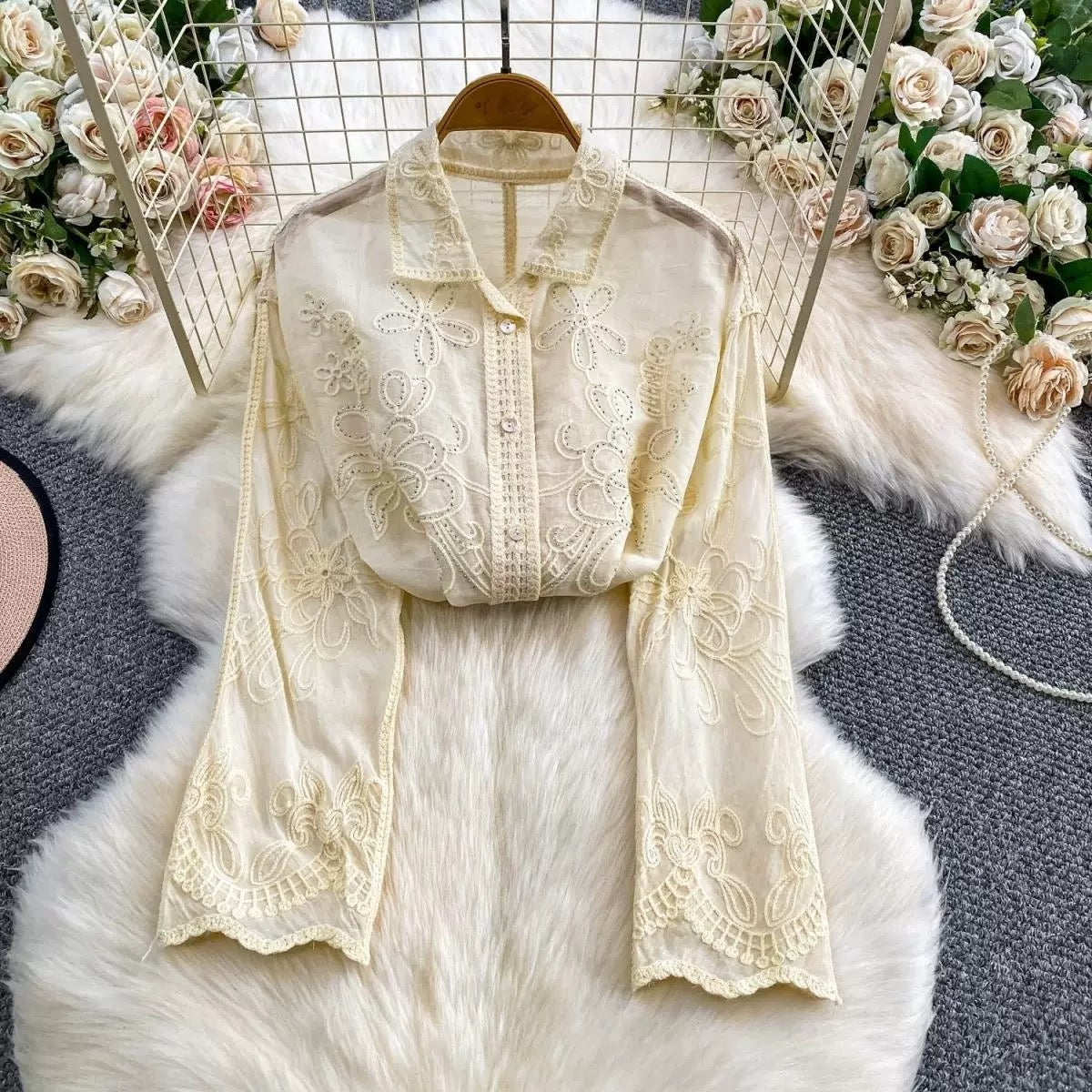 Seraphine Cutwork Cotton Shirt in ivory laid flat showing sleeve embroidery and scalloped cuff detail