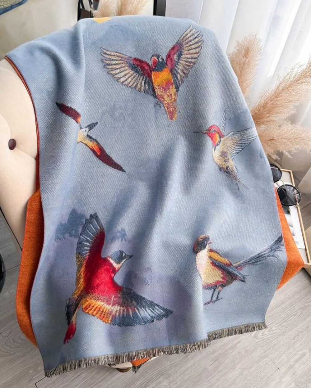 The Skybound Aviary Reversible Wrap laid flat showing both reversible sides with bird and botanical aviary print in contrasting color tones
