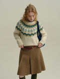 The Alpine Meadow ivory knit sweater with forest green and taupe Fair Isle-inspired Nordic pattern and ribbed cuffs