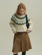 The Alpine Meadow ivory knit sweater with forest green and taupe Fair Isle-inspired Nordic pattern and ribbed cuffs