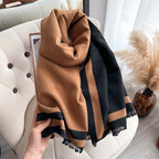     Close-up of The Signature Reversible Black & Tan Border Wrap showcasing its reversible black and tan color palette and premium jacquard faux cashmere fabric, size 182 x 65 cm.