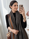 Urban Maze Cotton Stole styled on an elegant Indian woman wearing a black outfit, featuring a black and beige Greek key geometric print with camel-brown border.