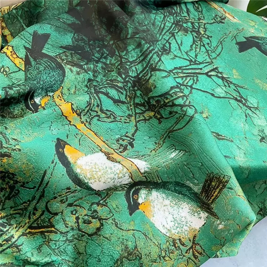 Close-up of Verdana Songbird Scarf silk-feel fabric with bird print