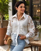 Woman wearing Vibe Eyelet Statement Shirt in white with crochet lotus pattern, styled with denim