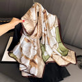 Botanical Sketch luxury silk stole by Westery styled beautifully over a black blouse on a hanger, showcasing the soft earth-toned palette, delicate brown borders, and artistic line-art floral prints.
