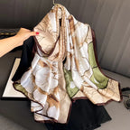 Botanical Sketch luxury silk stole by Westery styled beautifully over a black blouse on a hanger, showcasing the soft earth-toned palette, delicate brown borders, and artistic line-art floral prints.
