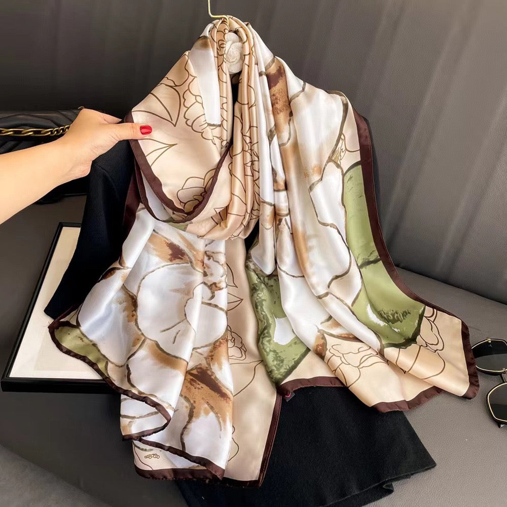 Botanical Sketch luxury silk stole by Westery styled beautifully over a black blouse on a hanger, showcasing the soft earth-toned palette, delicate brown borders, and artistic line-art floral prints.

