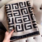 A hand holding the Grand Maze Graphic luxury silk stole by Westery, neatly folded inside a presentation frame to exhibit the crisp geometric pattern and smooth satin texture.
