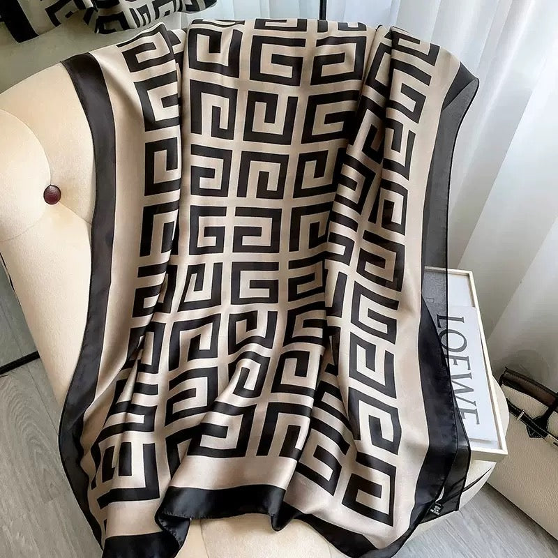 Full length view of the Westery Grand Maze Graphic premium silk scarf draped to display the repeating square maze print pattern and solid black border detailing.
