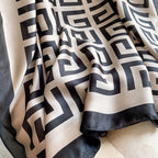 Close-up texture detail of the Westery Grand Maze Graphic premium silk scarf, showing the high-end fabric folds, soft satin sheen, and clean border stitching.
