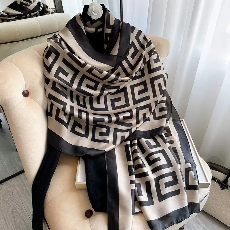 Westery Grand Maze Graphic luxury silk scarf styled in a cozy neck wrap on a hanger, highlighting the sophisticated contrast and elegant drape of the premium fabric.
