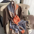 Westery luxury imitation silk scarf featuring a Greek key geometric print in taupe, charcoal grey and burnt orange, elegantly styled on a chair with a handbag.