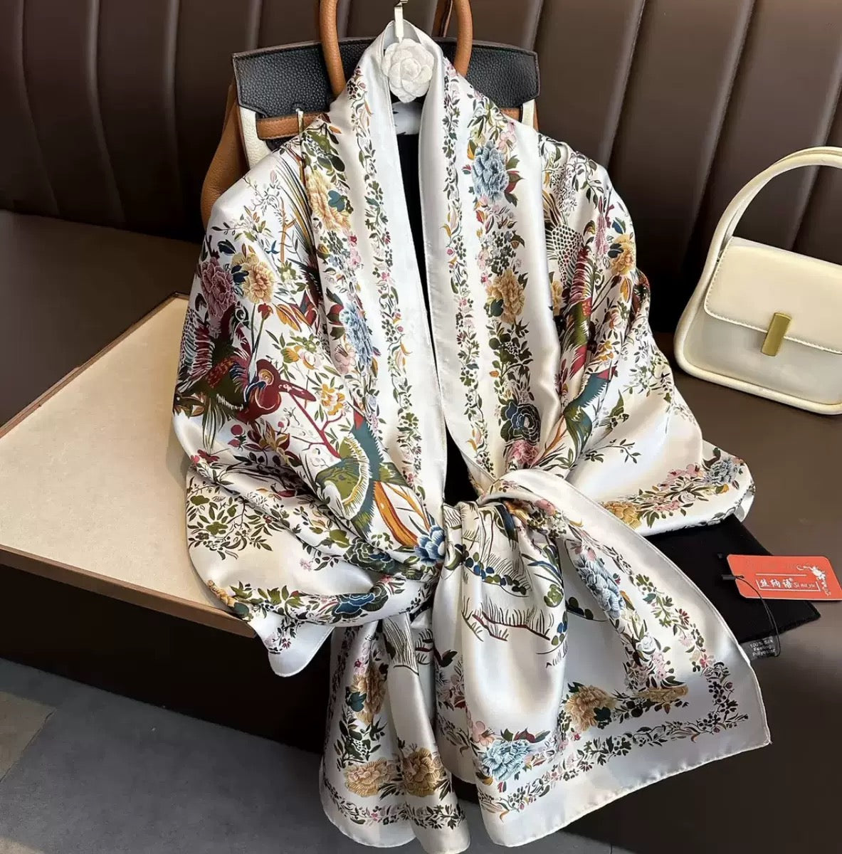 The Imperial Garden Bird & Bloom premium silk stole by Westery styled with an elegant front knot display, showcasing the symmetrical flower paths, exotic bird prints, and high-end satin sheen.
