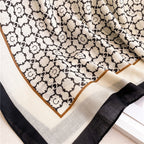 Close-up view of the Noir Lattice Monogram cotton viscose stole by Westery, emphasizing the fine breathable weave texture, clean print details, and sophisticated border finish.
