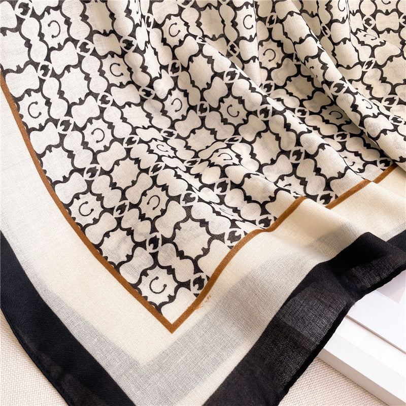 Close-up view of the Noir Lattice Monogram cotton viscose stole by Westery, emphasizing the fine breathable weave texture, clean print details, and sophisticated border finish.
