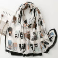 Whisker Tales premium viscose cotton stole by Westery draped naturally, featuring a whimsical array of illustrated cats in stripes, polka dots, and sweaters against a soft off-white background with a fringed black border.
