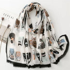 Whisker Tales premium viscose cotton stole by Westery draped naturally, featuring a whimsical array of illustrated cats in stripes, polka dots, and sweaters against a soft off-white background with a fringed black border.
