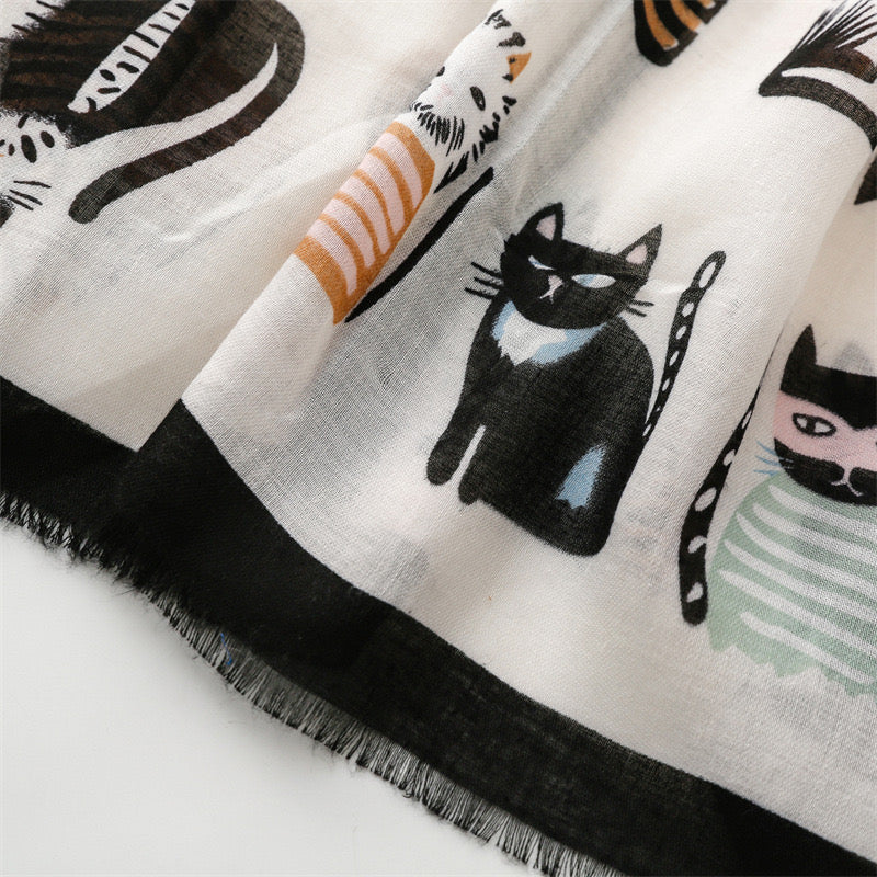 Detailed close-up of the Whisker Tales viscose cotton stole by Westery styled in a soft neck loop knot, showcasing how the lightweight fabric folds and stacks the artistic cat graphics elegantly.
