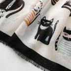 Detailed close-up of the Whisker Tales viscose cotton stole by Westery styled in a soft neck loop knot, showcasing how the lightweight fabric folds and stacks the artistic cat graphics elegantly.
