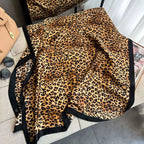 Full layout of the Westery Wild Luxe Leopard premium silk scarf spread out to display the detailed leopard spot pattern and the smooth satin sheen of the luxury fabric.
