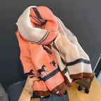 Close-up display of the Westery Wild Spirit Equestrian colour block stole, highlighting the lightweight viscose-cotton weave blend, rich peach and cream panels, and belt-strap print detailing.
