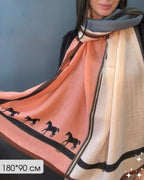 Wild Spirit Equestrian colour block viscose cotton stole by Westery worn by a model, showcasing the soft peach panel detailed with black running horse silhouettes.
