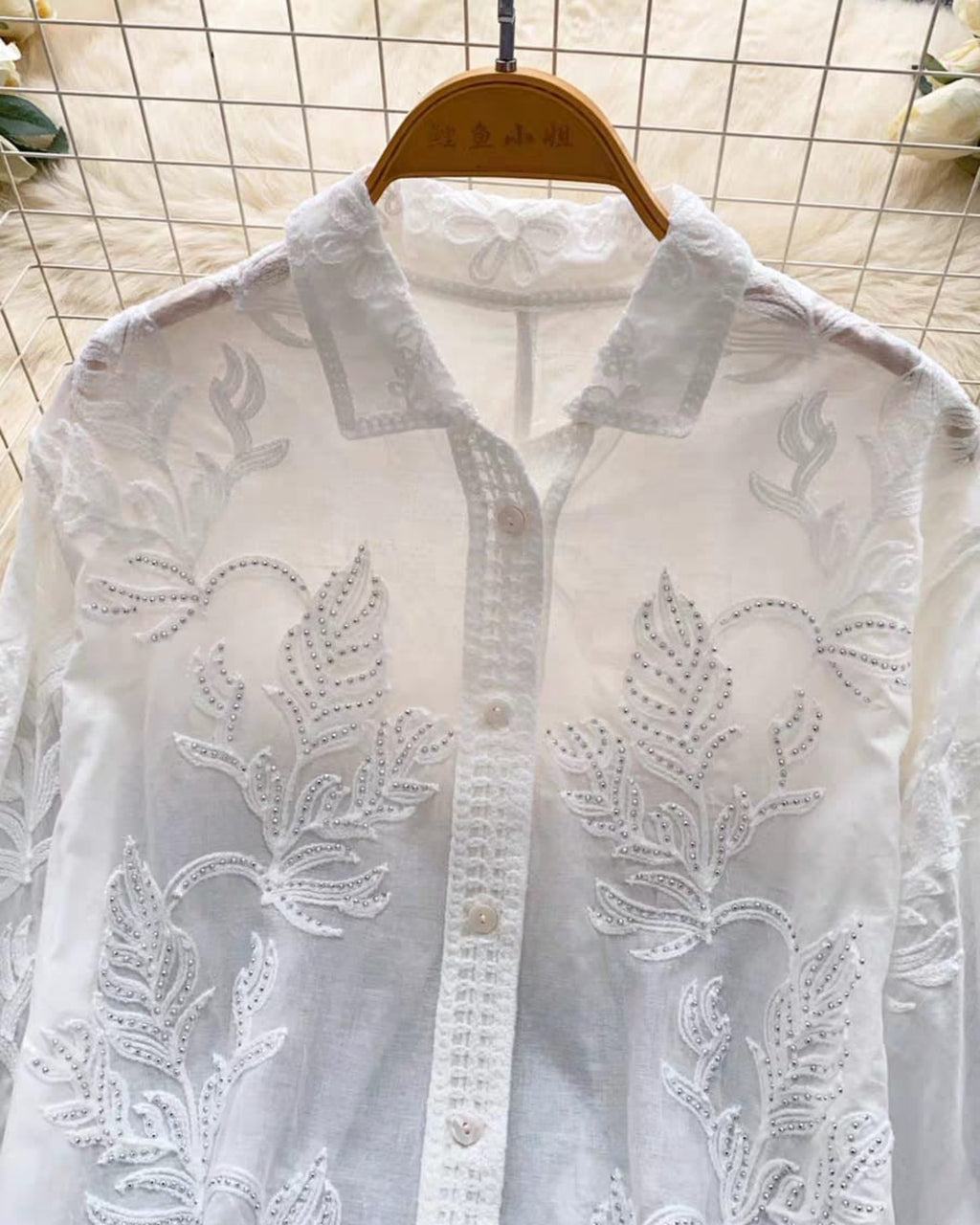 White linen sequin shirt front detail with pearl buttons and decorative lace placket