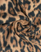 Close-up of The Wild Elegance Winter Wrap showing soft faux cashmere fabric texture with detailed refined wild animal print in sophisticated tonal shades
