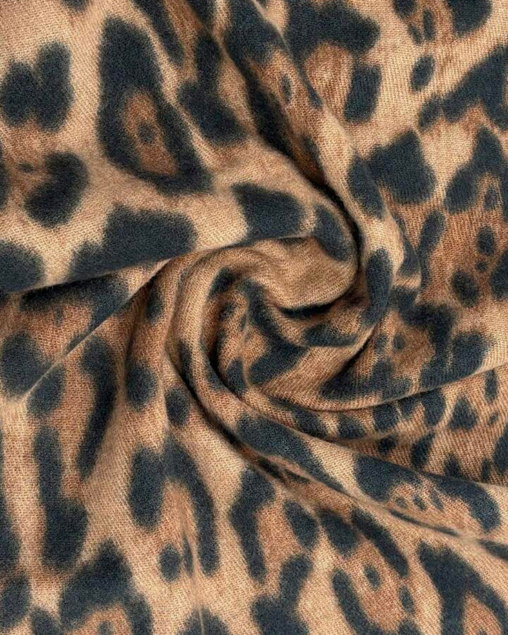 Close-up of The Wild Elegance Winter Wrap showing soft faux cashmere fabric texture with detailed refined wild animal print in sophisticated tonal shades
