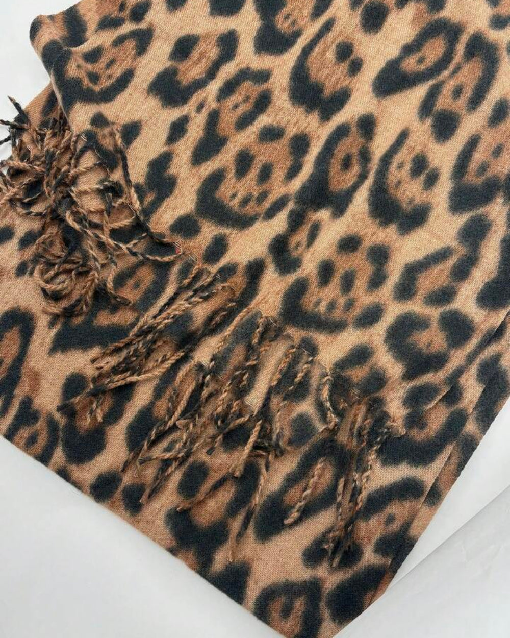The Wild Elegance Winter Wrap shown as shoulder shawl or flat lay displaying full wild animal print and generous 200x68cm size
