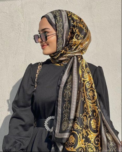 Woman wearing baroque print silk scarf as headscarf with sunglasses - luxury black gold scarf styling