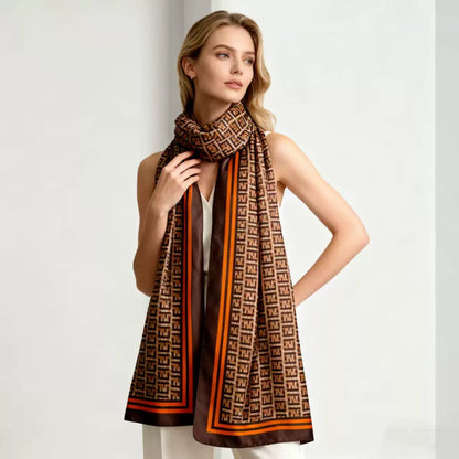 Woman wearing designer geometric monogram scarf with white top - elegant draping style brown beige orange
