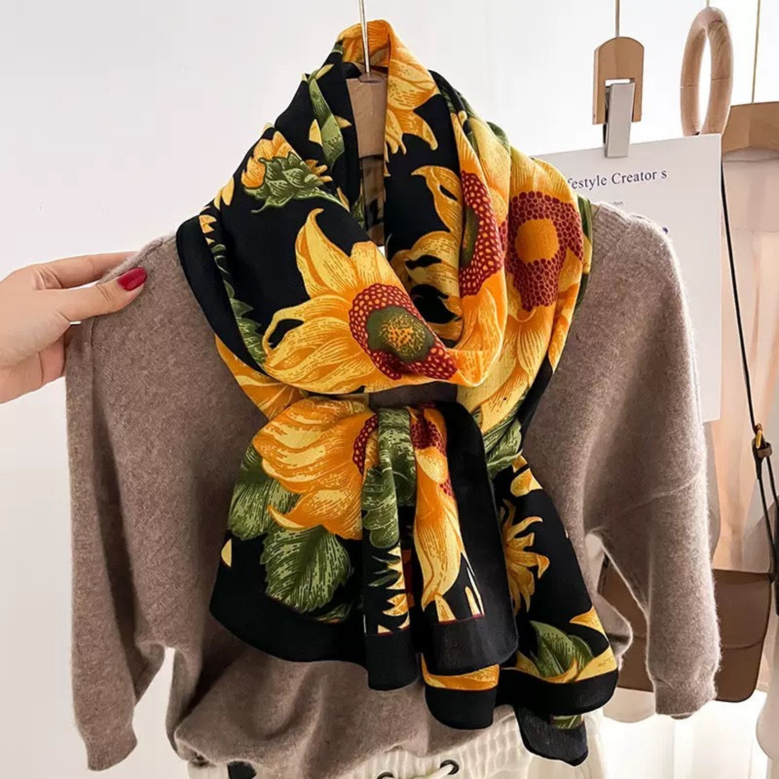 Woman wearing sunflower print viscose cotton scarf with beige sweater - casual floral scarf styling